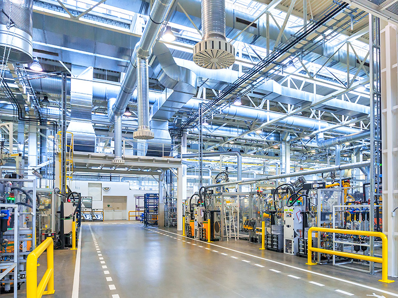 Industrial aisle with marked truck and pedestrian lanes and protective barriers showing the clearance an aisle must keep
