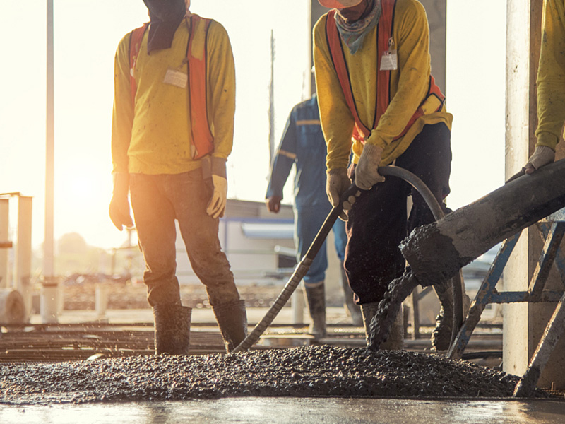 Concrete being placed on a structural slab, illustrating how a floor is built and why an upper floor or mezzanine has different limits from a ground slab
