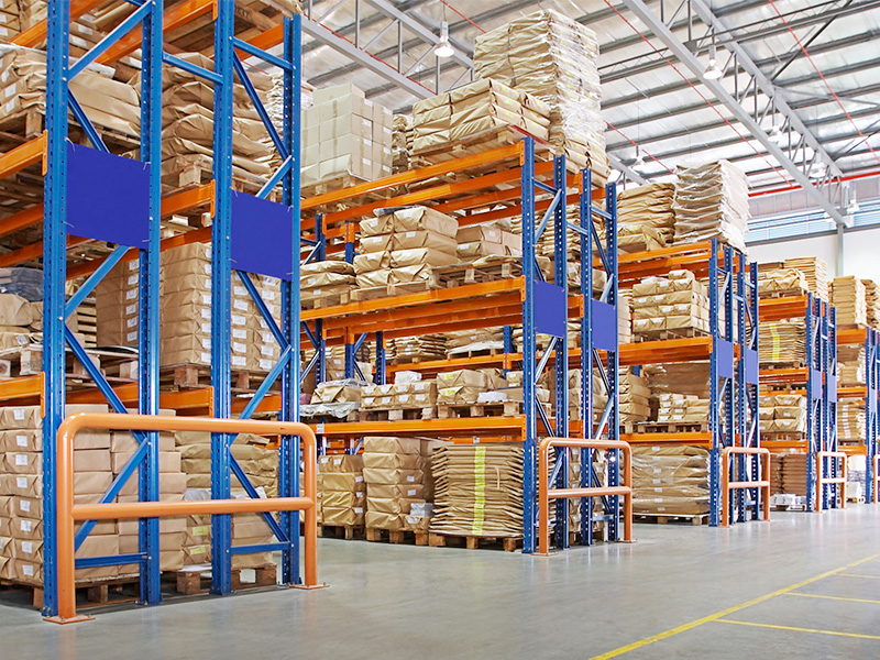 Warehouse aisle layout with pallet racking, floor markings and safety barriers where a forklift charging area is planned